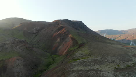 Ojo-De-Pájaro-Orbitando-Alrededor-De-Un-área-Geotérmica-Con-Cráteres-De-Agua-Caliente-Al-Vapor-En-Islandia.-Vista-Aérea-Que-Muestra-El-Paisaje-De-Pastizales-Con-Géiseres-Y-Fumarolas.-Belleza-En-La-Naturaleza