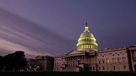 the us capitol building illuminated at dusk