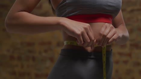 woman measuring her waist