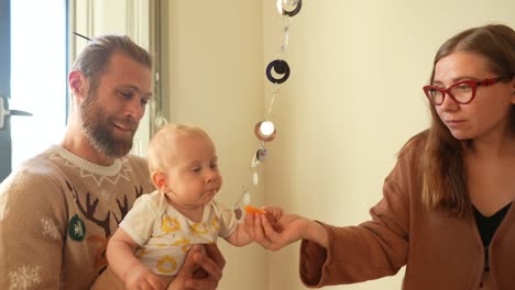 parents feeding baby