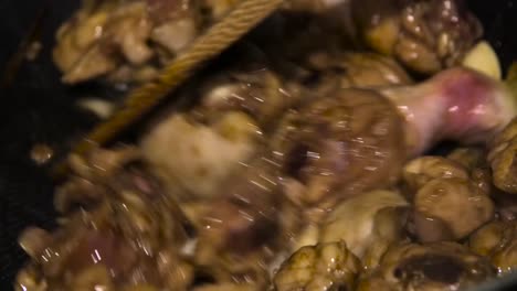 close up slow motion shot cooking chicken stirfry