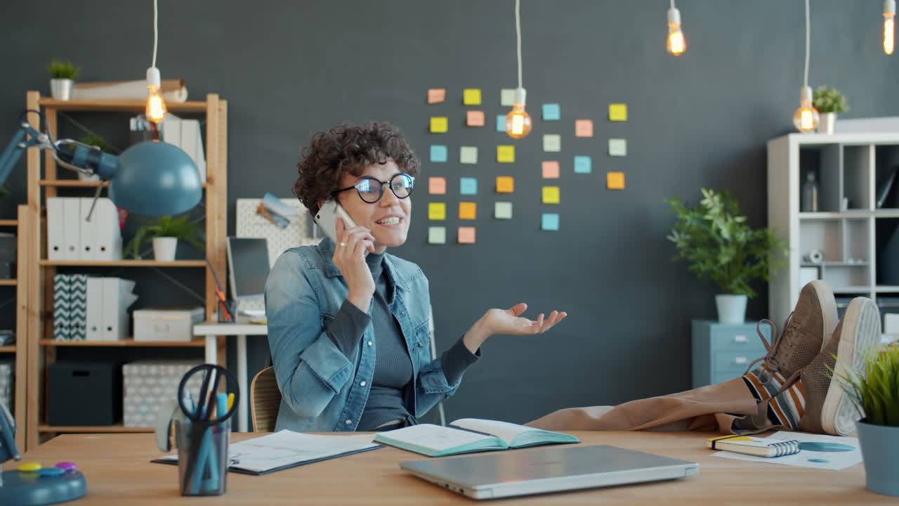 Woman in a Modern Office on a Phone Call