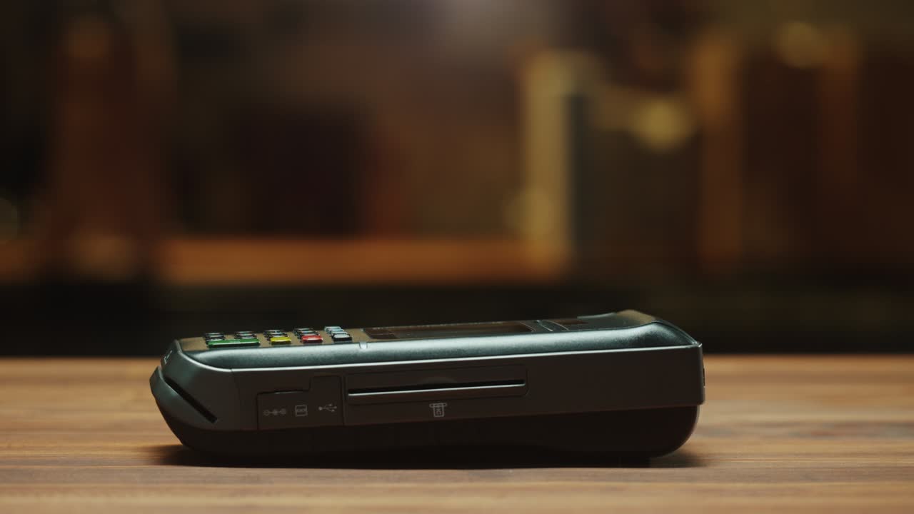 Paying with credit card close-up. Cashless shopping in restaurant or cafe. Touch-free and contactless payment concept. NFC technology and bank terminal.