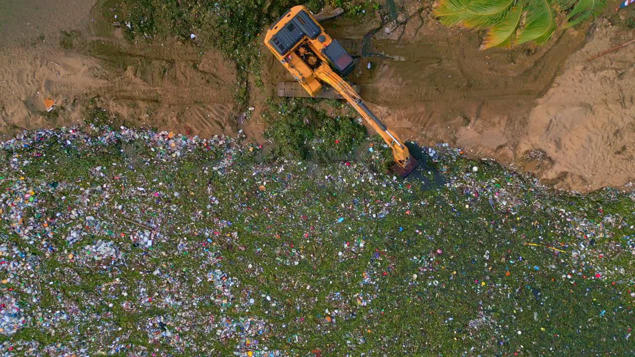 Aerial View Of Excavator Removing Marine Debris - Beach Pollution And Contamination