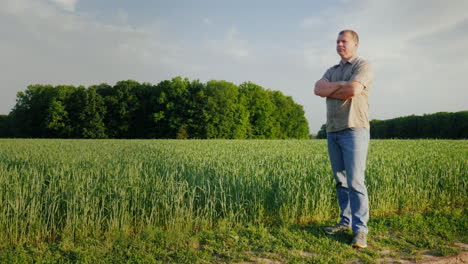 middle-aged self-confident farmer examines his field full-length person the owner of a small busines