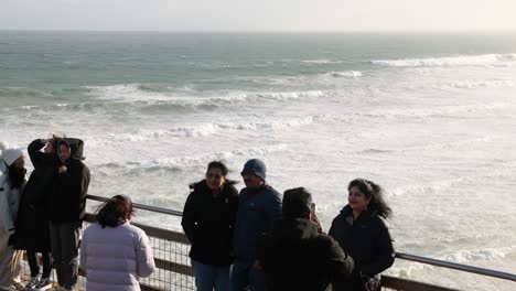 friends posing for a photo by the ocean