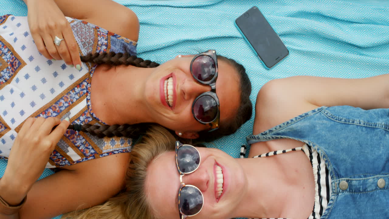 두 명의 여성이 여름 휴가를 즐기며 휴식을 취하고 있습니다.