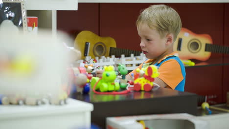 boy playing with toys in game room