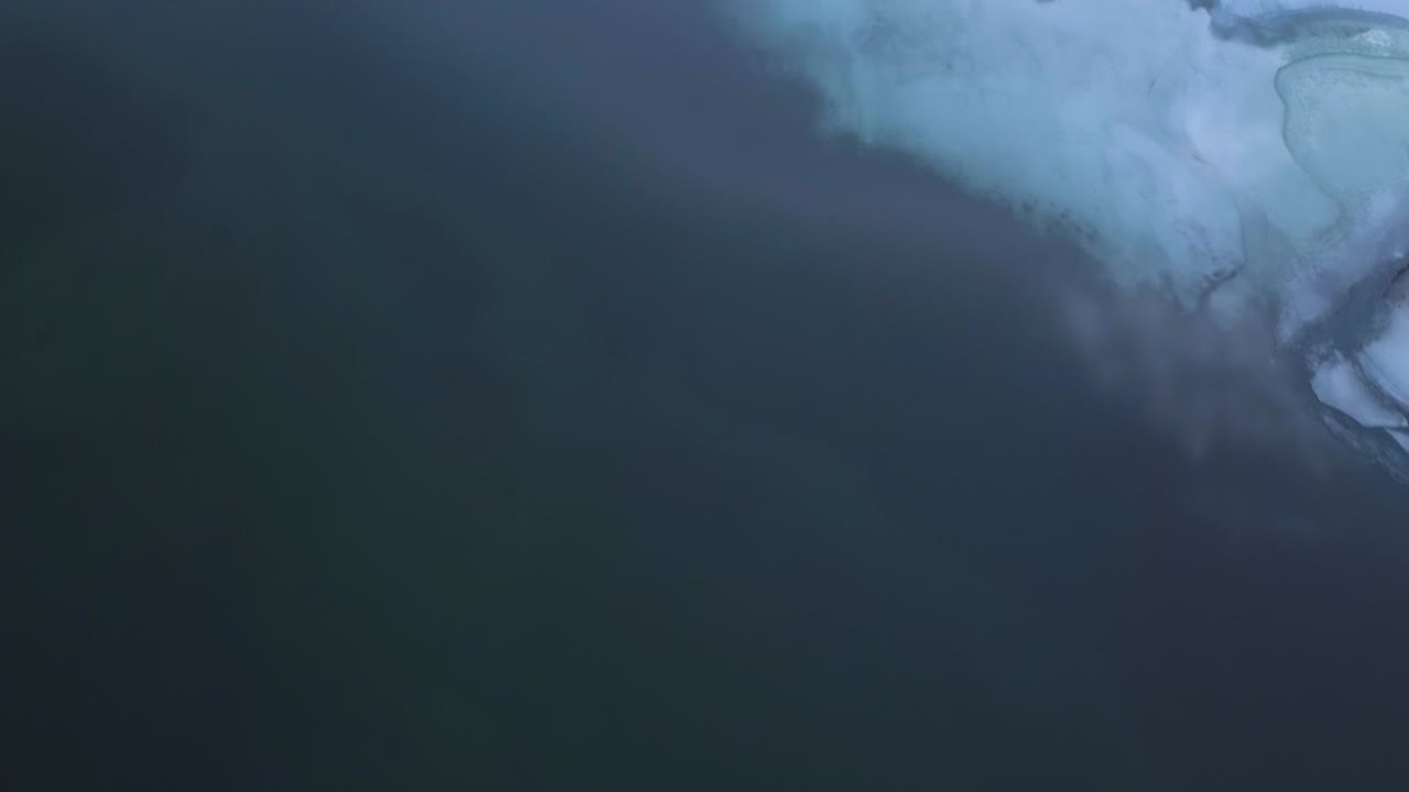 Flight over a lake with ice and snow on it
