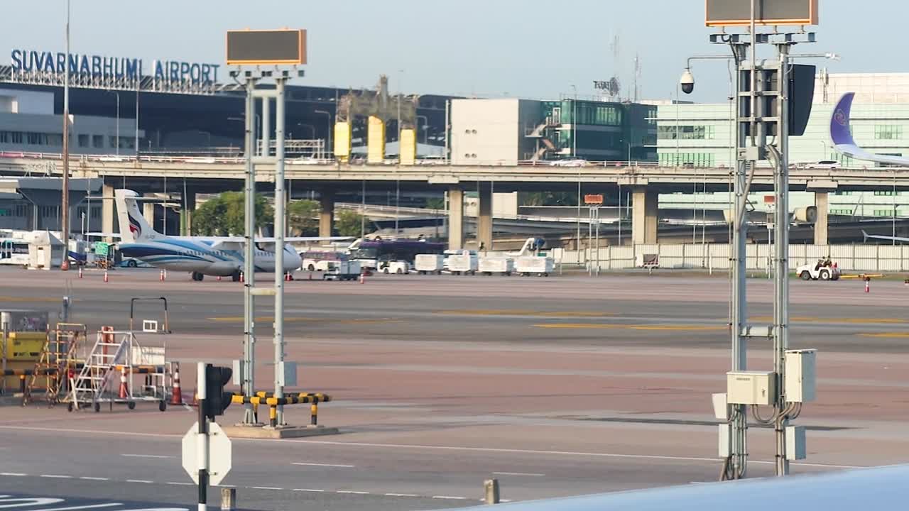 Close-up views of aircraft and terminal buildings at Suvarnabhumi Airport, showcasing airport infrastructure and operations.