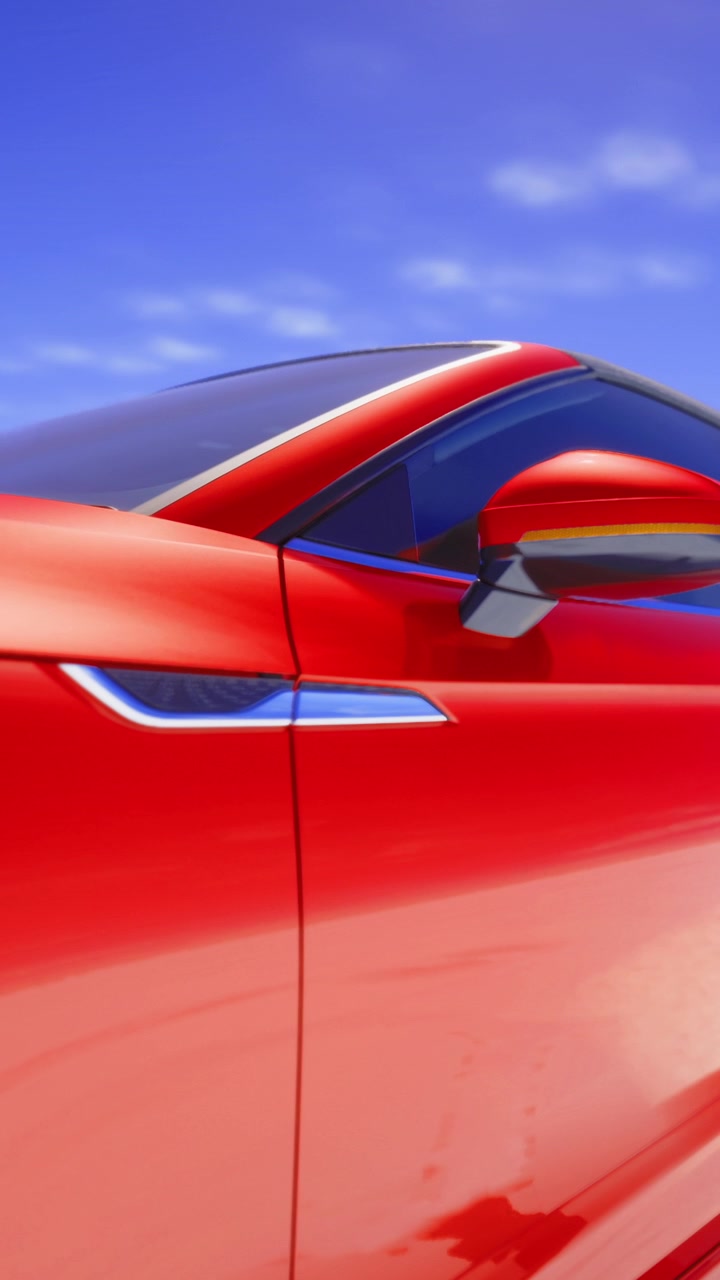 Rotes Auto tagsüber unter strahlend blauem Himmel geparkt.