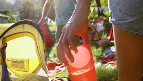 Close-up-of-woman-hipster-giving-a-water-glass-to-her-friend