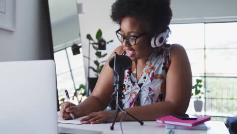 African-american-female-plus-size-vlogger-sitting-using-computer-having-a-video-chat