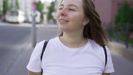 woman smiling and walking on the street