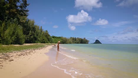 yellow bikini allure: a girl with a straw hat relishes the sea on a paradise island, embodying travel, tourist, and outdoor vacation concepts