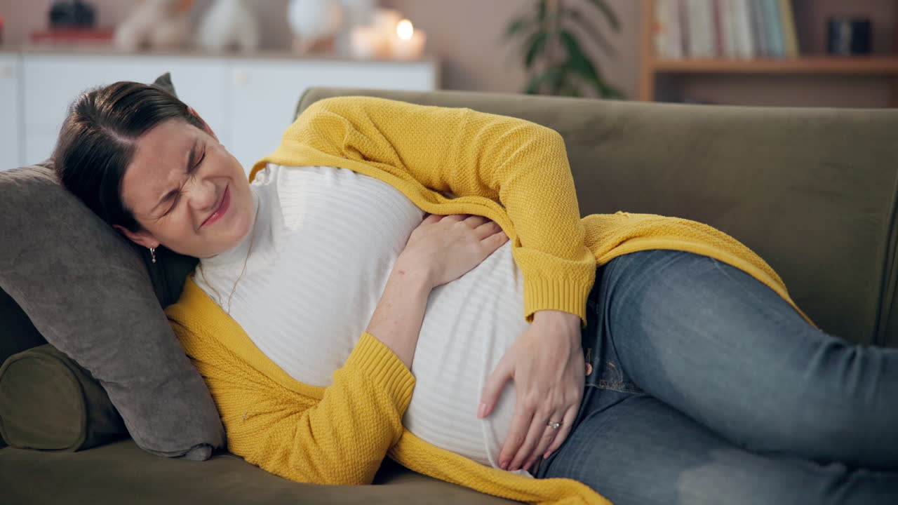 Pregnant woman experiencing labor pains at home