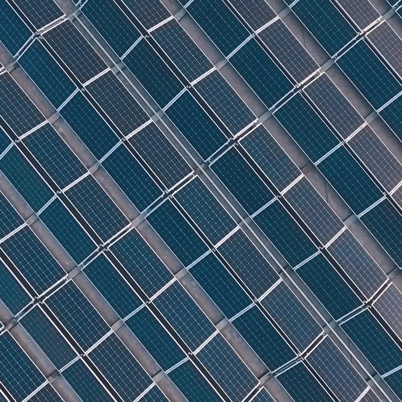 Solar panels outdoors. Landscape picture of solar farm. Green alternative energy concept. Aerial view. Camera rises up.