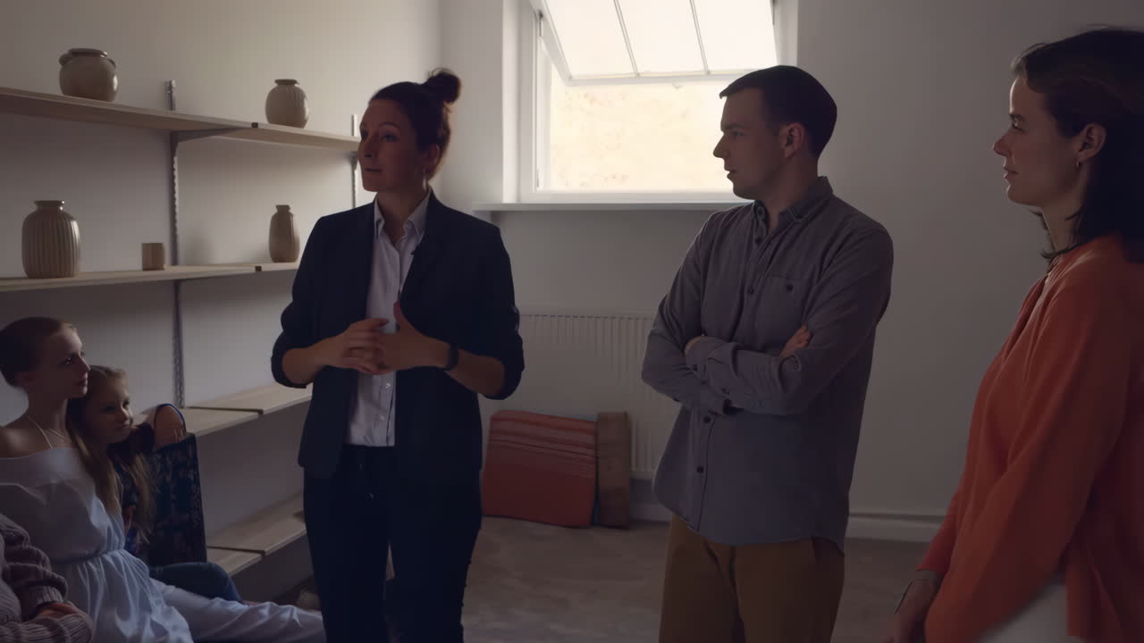 A group of people having a discussion in a room