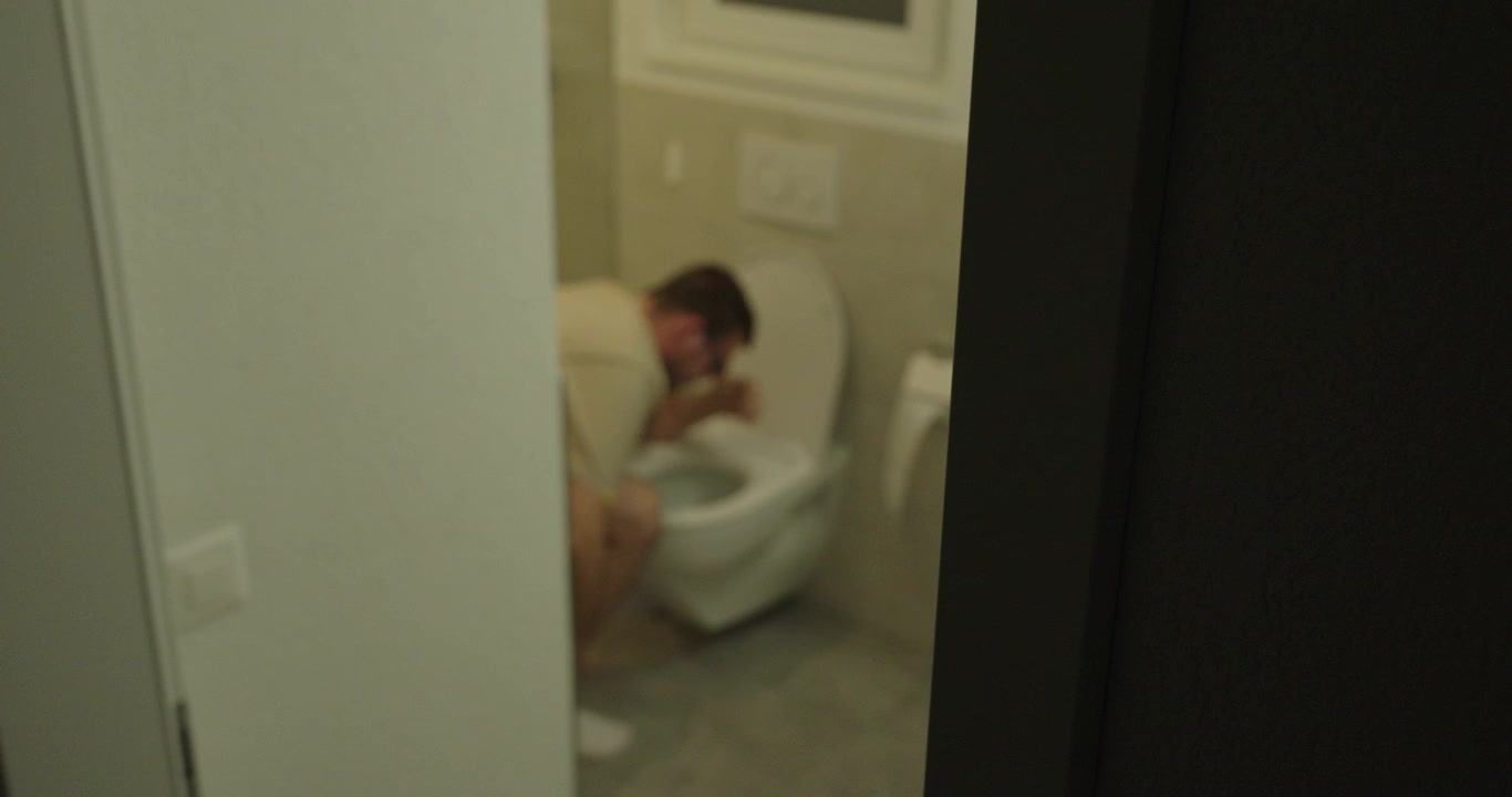 Man rushing to a toilet and vomiting due to nausea or stomach illness. Concept of sickness, food poisoning, digestive problems, health emergency, and medical symptoms.