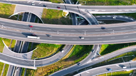 automobiles moving quickly by the highways, freeways and road loops. modern road system from top view.