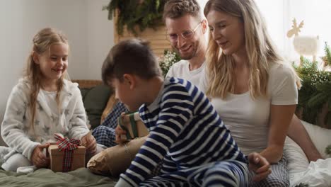 little boy runs to his family on christmas morning