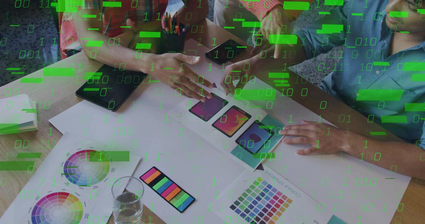 Design team sitting swapping mockups tapping screens revealing green code highlighting data flow
