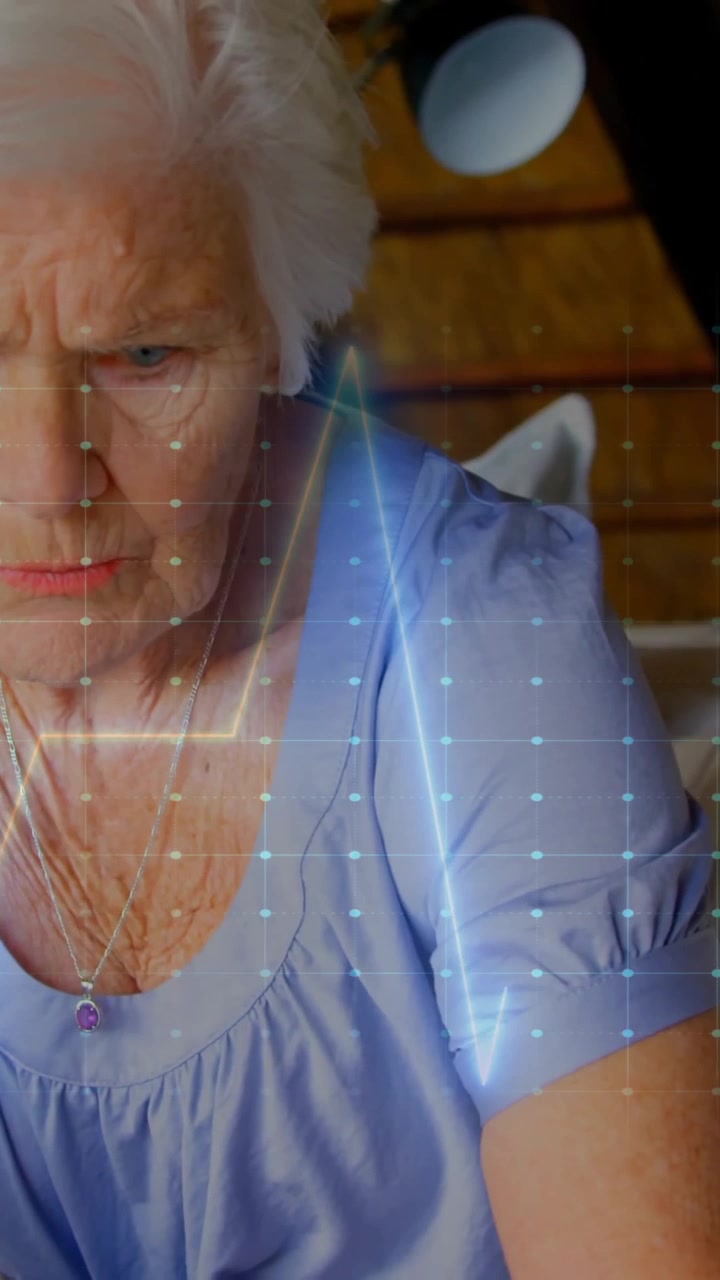 Animation of cardiograph over senior caucasian woman at home