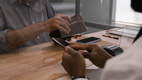 customer paying with wallet at a business