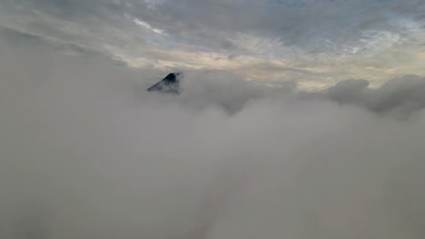Peak-of-Mount-Merapi-revealing-from-clouds-Java,-Indonesia,-Aerial-view