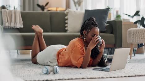 Laptop,-coffee-and-woman-on-the-floor-in-living