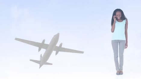 animation of happy african american woman using smartphone, over plane in sky