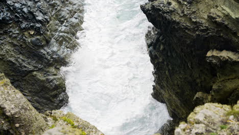 waterfall cascading through rocky crevice