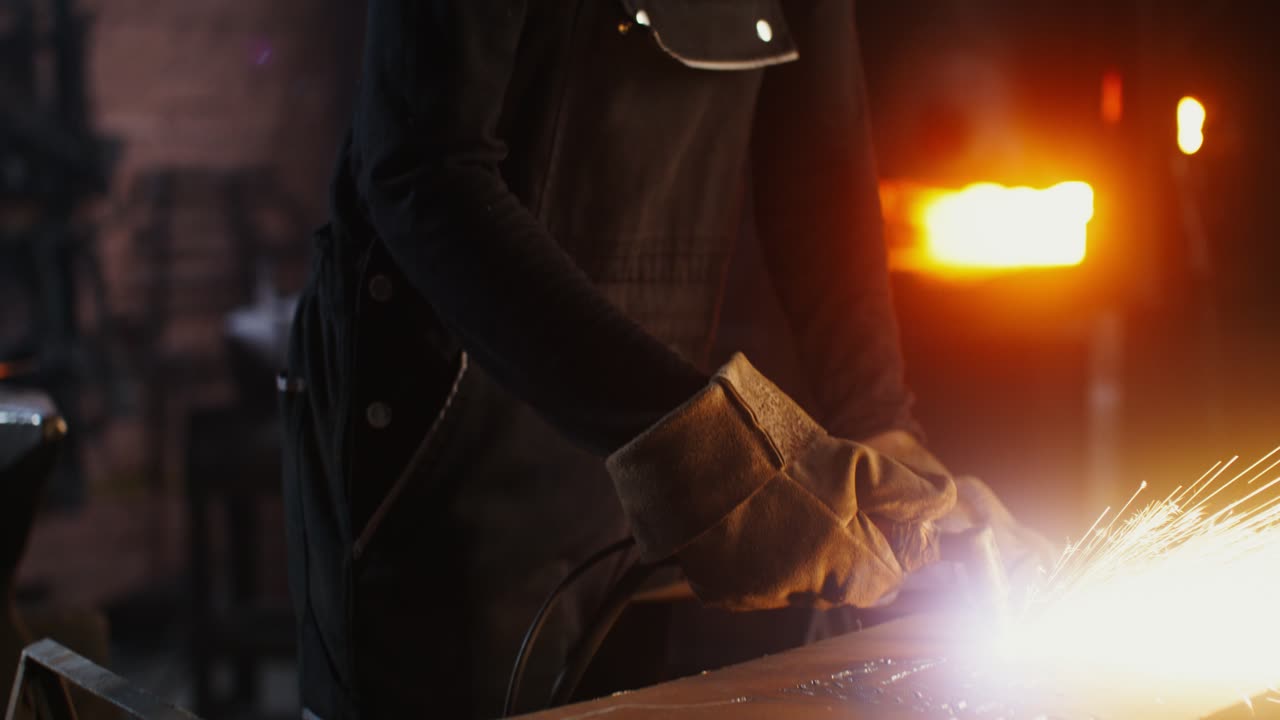 Metalworker at Work in a Dark Workshop