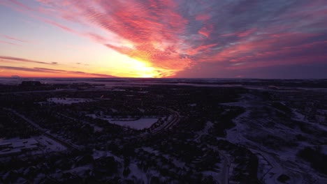 drone footage of calgary's houses during a beautiful winter sunrise in a winter wonderland