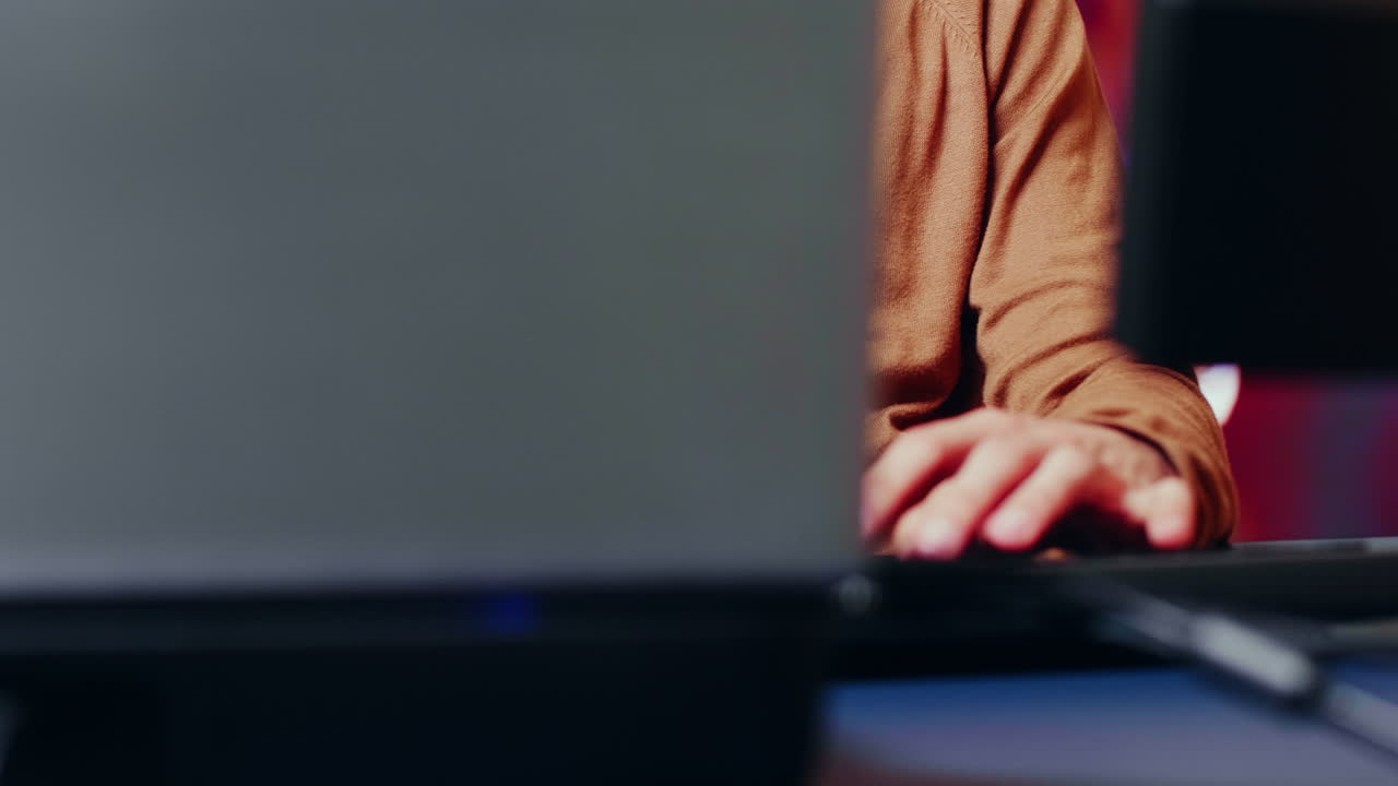 View of young game developer working on computer