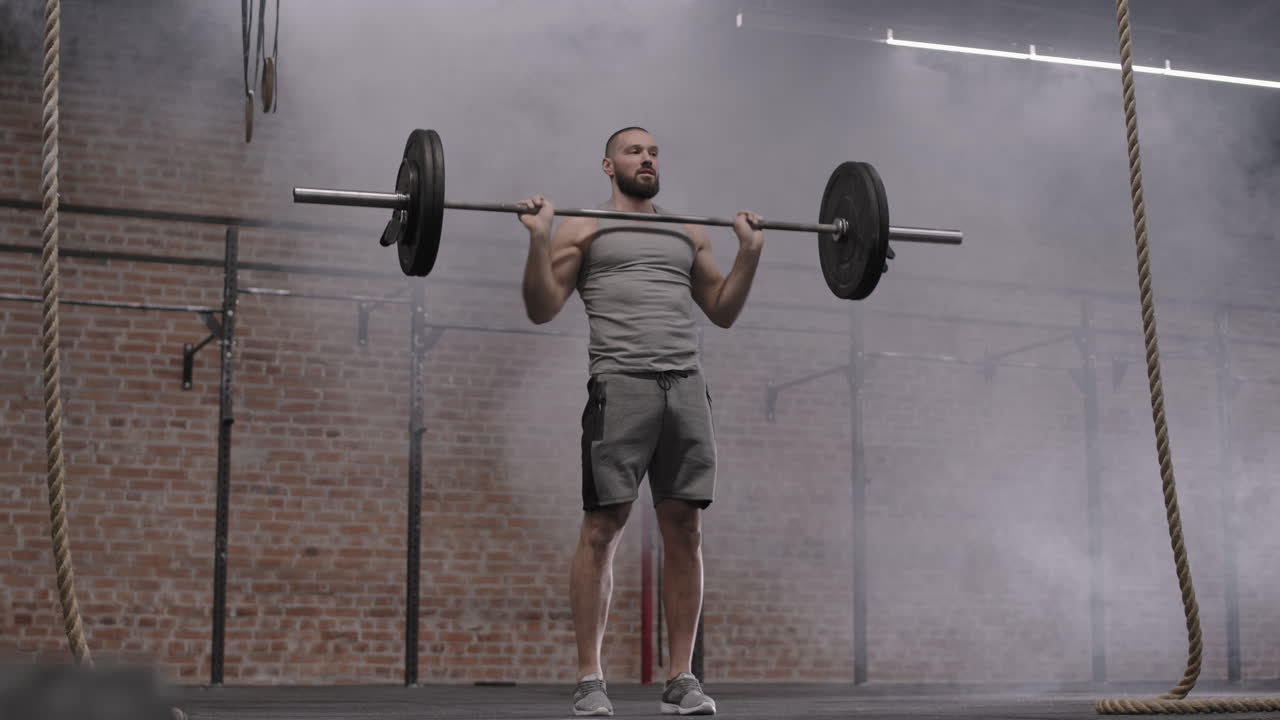 Male Powerlifter Lifting Heavy Barbell in Gym