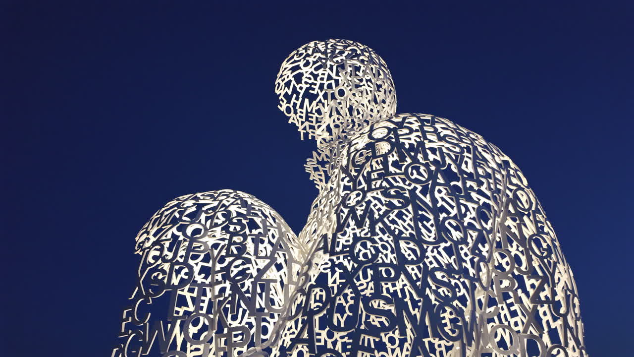 The Nomad urban sculpture by Jaume Plensa illuminated in the evening in Antibes, France