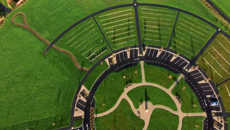 modern circular cemetery pathway design aerial view artistic garden of rest birdseye reverse shot