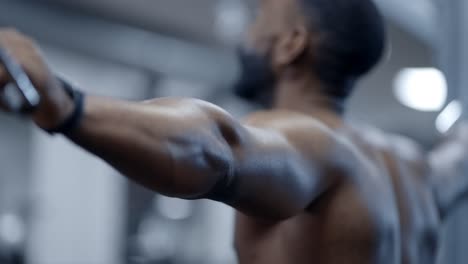 an athletic african american man completes set of chest flys
