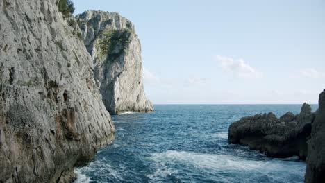 side view of the faraglioni in capri, in italy, during a sunny day in spring