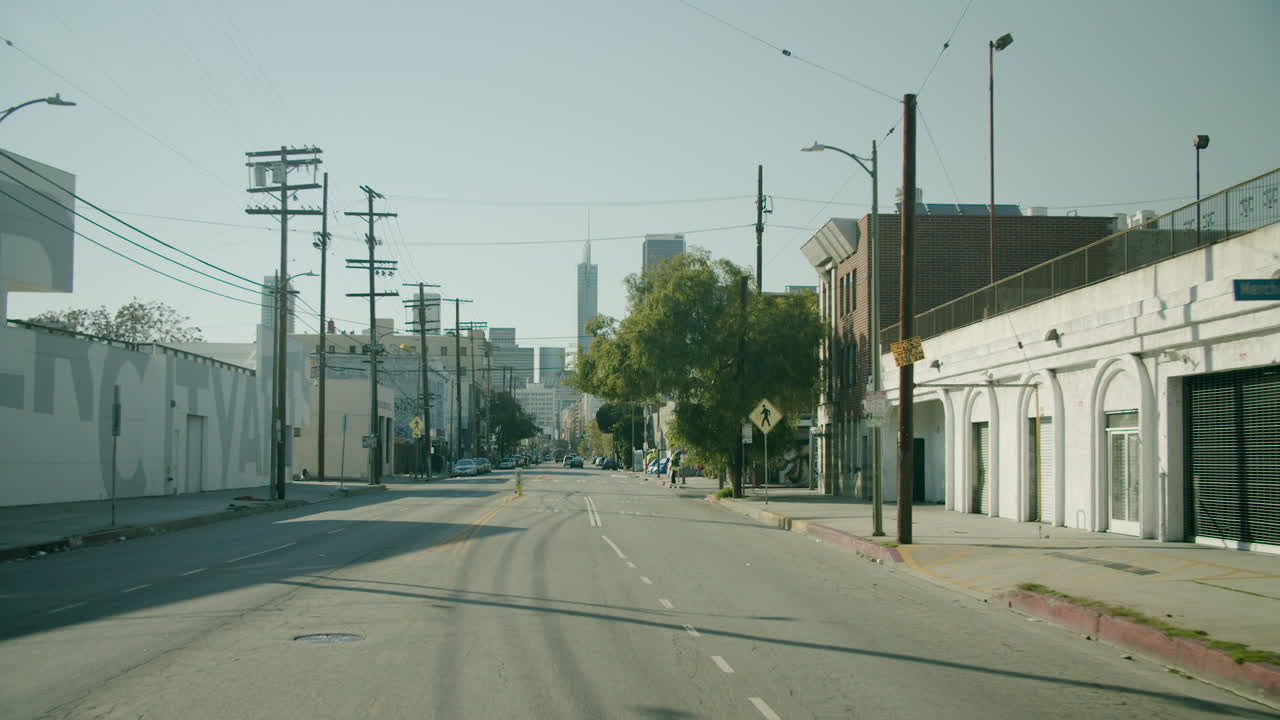Urban street view with distant city skyline and utility poles