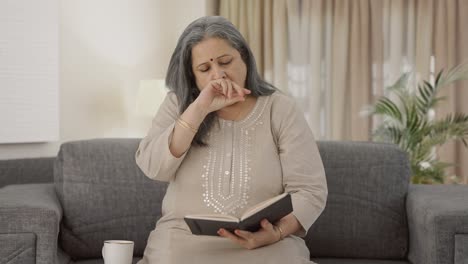 Sleepy-Indian-old-woman-reading-a-book-in-morning