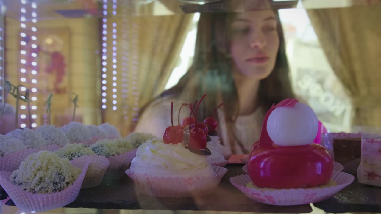 Woman looking at desserts in a pastry shop