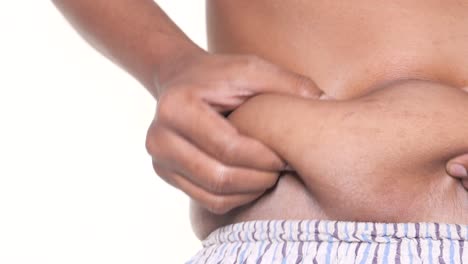 close-up of a man pinching excess fat on his waist