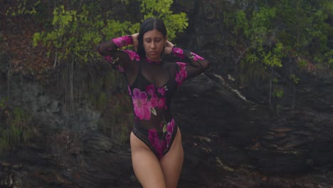 on a picturesque caribbean cliffside beach, a latin girl poses in lingerie.