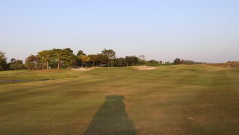 progression of a peaceful walk on a golf course at dusk.