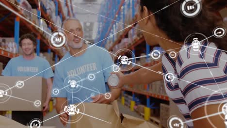 animation of network of connections with icons over diverse workers in warehouse