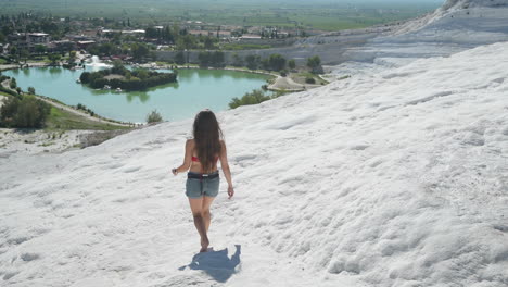 Back-View-of-Young-Woman-Walking-Barefoot-on-White-Travertines-of-Pamukkale,-Turkey,-Slow-Motion