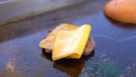 heating-burger-and-cheese-on-grill