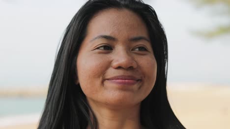 Happy-Thai-Woman-Combing-Her-Hair-By-Hands-At-The-Beach